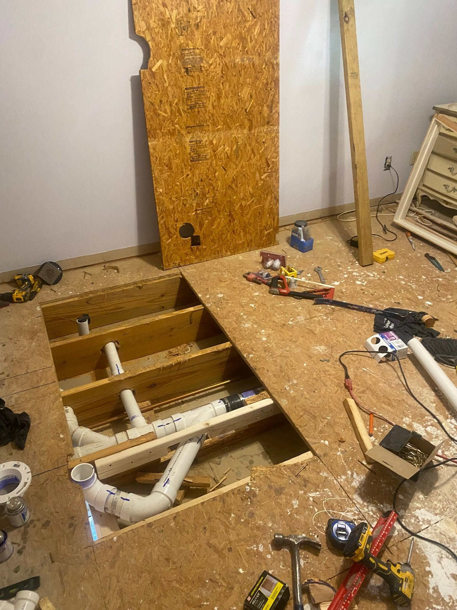 Subfloor opened with PVC plumbing rough-in during full bathroom addition — Metro Atlanta, GA