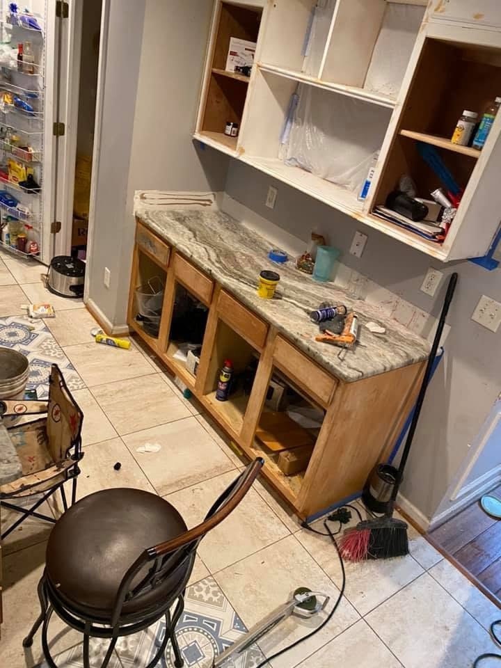 Kitchen cabinets stripped and prepped for painting — doors removed, blue tape on walls, Metro Atlanta, GA
