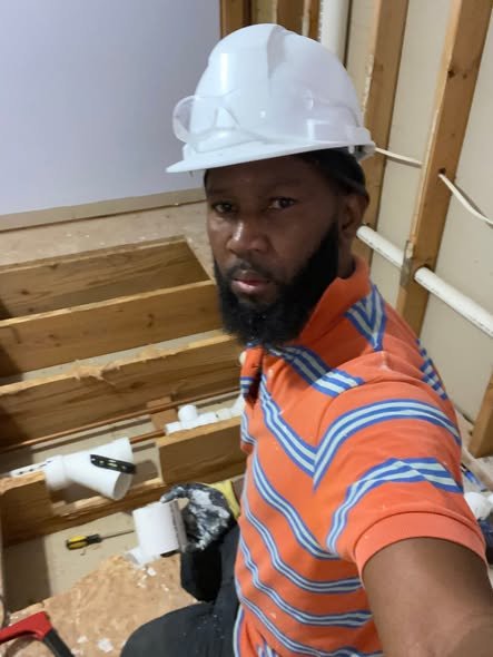 Richard running PVC supply lines inside open wall framing during plumbing rough-in — Metro Atlanta, GA