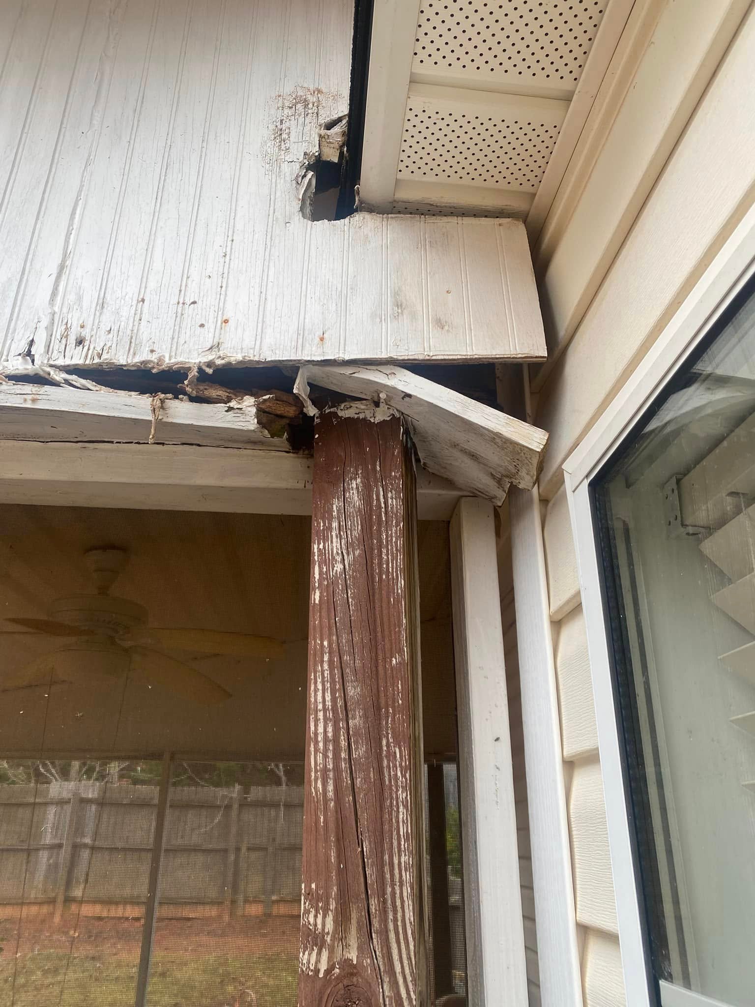 Porch before repair — severely rotted column and fascia board with structural damage and peeling wood