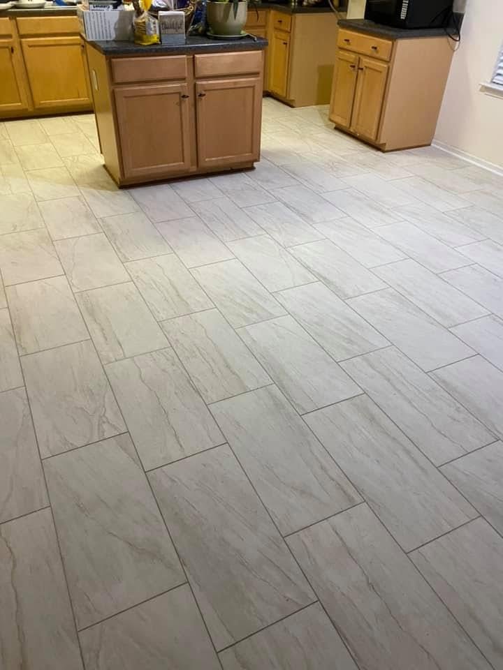 Large format marble-look porcelain tile installed throughout a full open kitchen — Metro Atlanta, GA